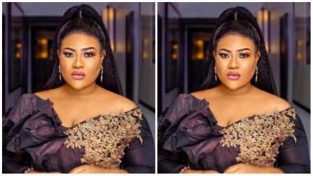 Nkechi Blessing, Nigerian actress, poses in an elegant off-shoulder black gown with intricate gold floral embroidery, styled with drop earrings and bold makeup.
