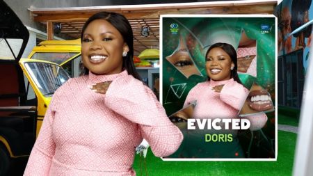 BBNaija Season 10 housemate Doris smiles brightly in a pink patterned dress. Beside her is her eviction poster with the words “Evicted Doris,” confirming her exit from the show.