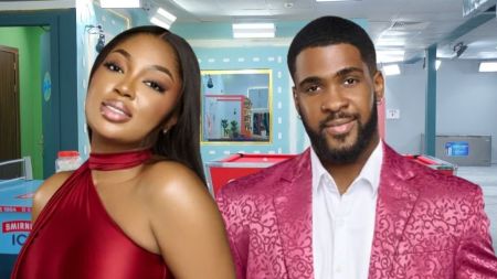BBNaija Season 10 housemates Mide and Bright pose together in the house. Mide wears a bold red halter-neck dress with soft glam makeup, while Bright stands beside her in a patterned pink suit jacket over a white shirt, both smiling confidently at the camera.