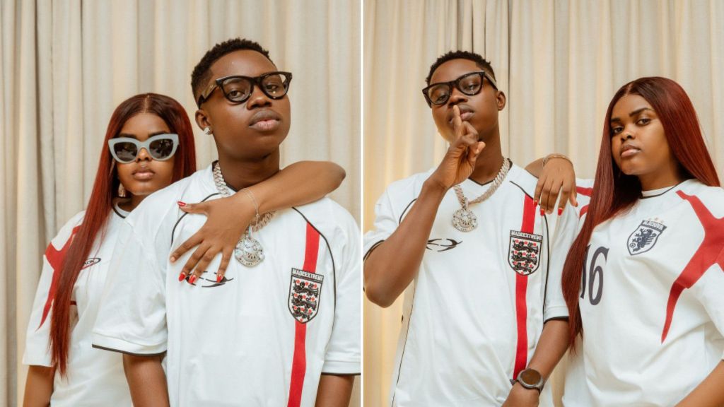 Side-by-side photos of Peller and Javis posing together in matching white England football jerseys, accessorised with dark glasses, jewellery, and casual expressions against a cream curtain backdrop.