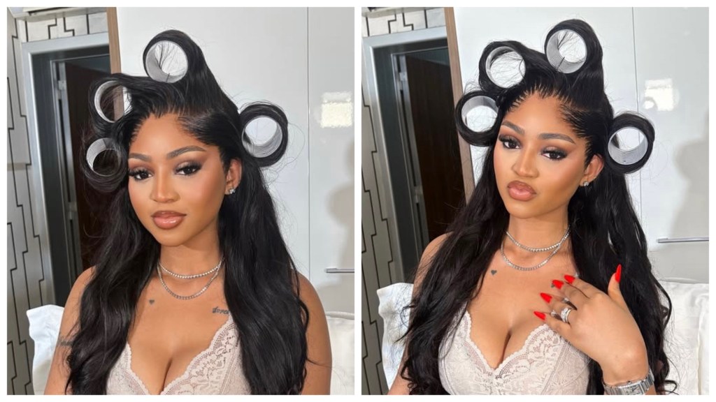 Regina Daniel’s with red nails and hair rollers on which she types who her enemy is.