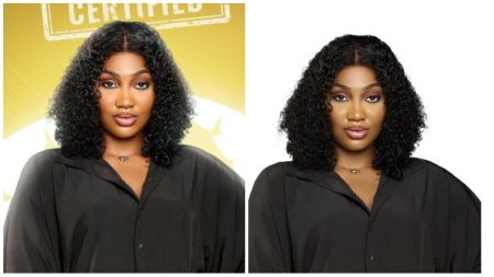 BBNaija housemate Sultana poses in a black button-down shirt with curly hair, looking straight at the camera.