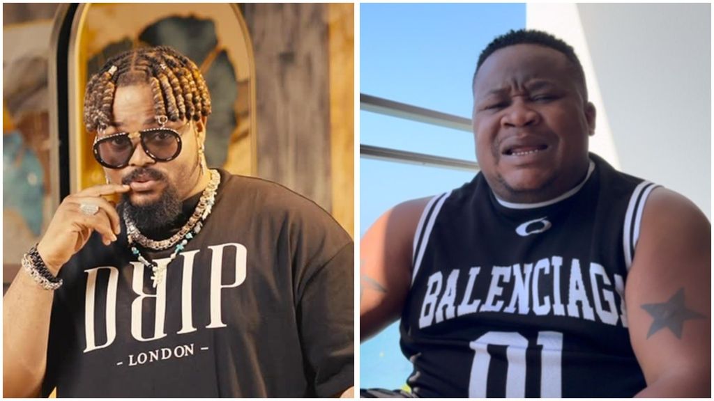 Nigerian singer Whitemoney wearing a black “DRIP London” t-shirt accessorised with sunglasses and chains, alongside nightlife promoter Cubana Chief Priest in a sleeveless black “Balenciaga” shirt with a star tattoo on his arm.