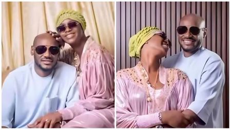2Baba (Innocent Idibia) and his wife Annie Idibia share a warm moment in coordinated pastel outfits, smiling and embracing while wearing sunglasses.