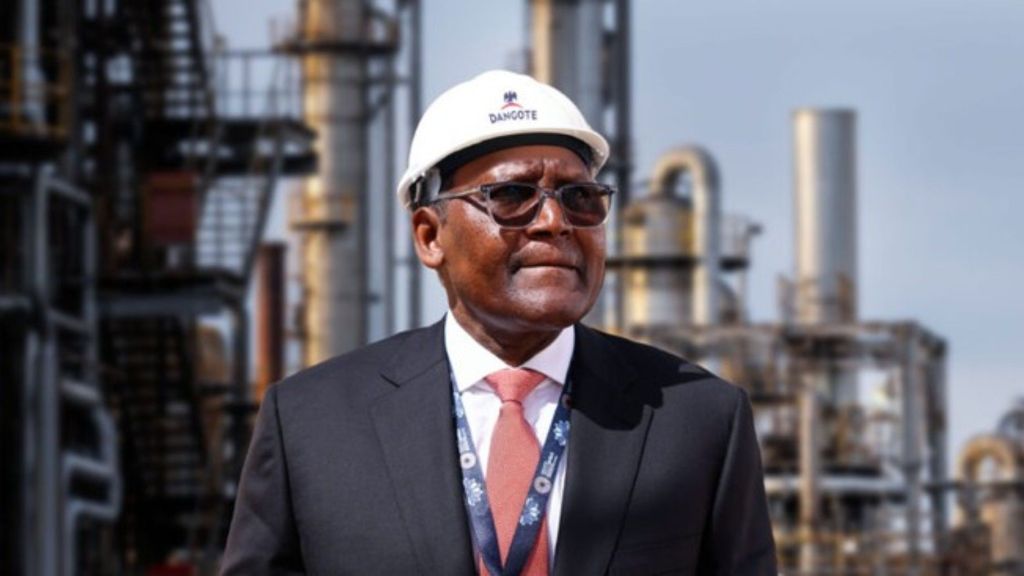 Aliko Dangote wearing a suit and safety helmet at the Dangote Refinery complex in Lagos, Nigeria.