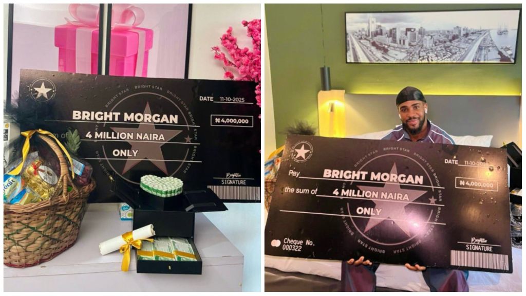 BBNaija star Bright Morgan poses with a large mock cheque of ₦4 million from his fans, alongside gift baskets and cash boxes displayed on a table.