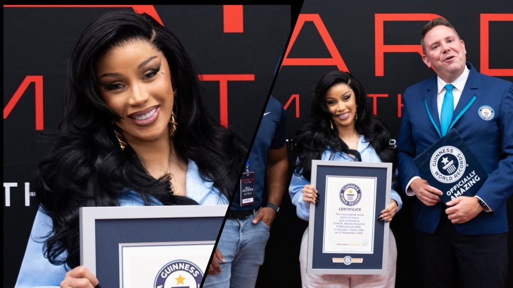 Cardi B smiles while holding her Guinness World Records certificate, celebrating her new achievement at an official recognition event.