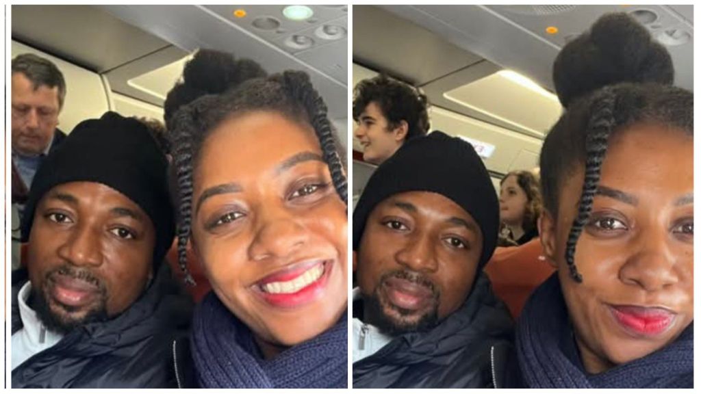 Cheta Umeh and his wife smiling for selfies while seated together on an aeroplane, both dressed warmly in jackets and scarves during their flight.