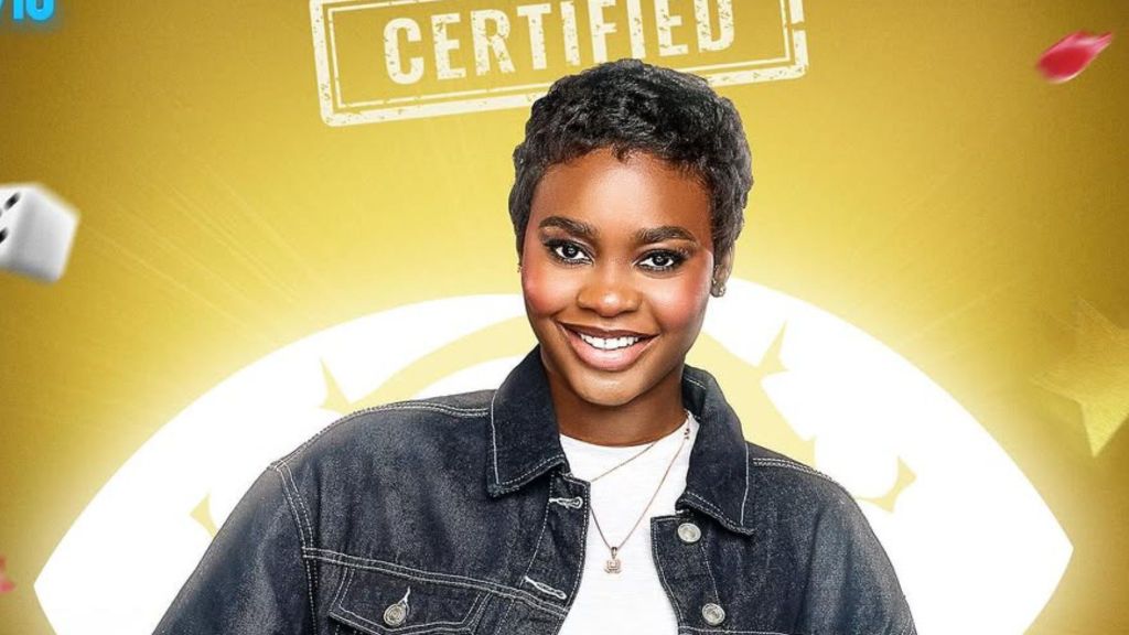 BBNaija Season 10 housemate Dede smiles in her official portrait, wearing a denim jacket over a white top against a gold background with the “Certified” logo above her.