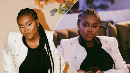 Nigerian music video director Praise Onyeagwalam, popularly known as Director Pink, poses confidently in two photos. She wears a white embellished jacket over a black outfit, with her hair styled in neat braids. In one image, she looks directly at the camera; in the other, she sits holding a phone, appearing thoughtful under soft indoor lighting.