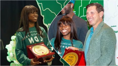 Comedienne Emmanuella beams with joy as she receives an honorary award, holding a gold-plated plaque while posing with an official during the presentation ceremony.