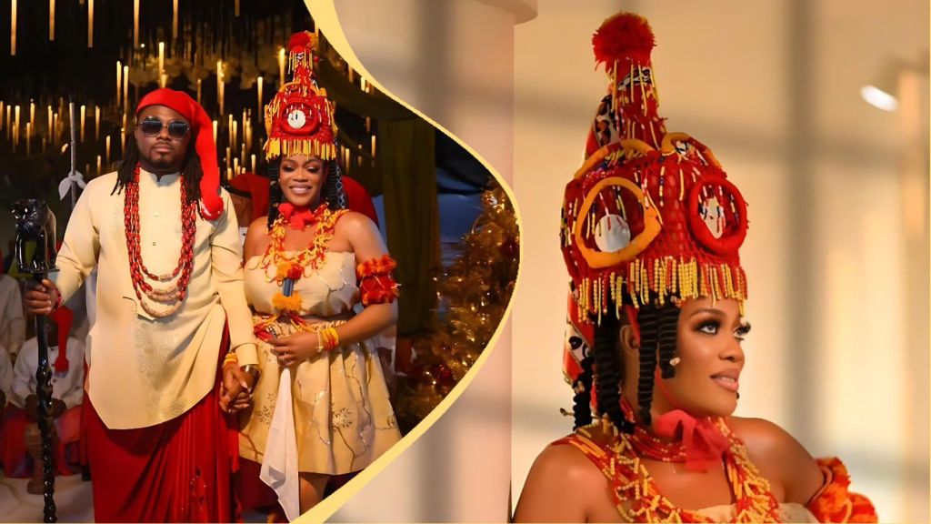 Eve Esin and her husband dressed in traditional attire at their wedding ceremony. The actress wears a gold and red beaded gown with a striking red coral headpiece, while her groom appears in a cream and red outfit adorned with coral beads, holding a black staff. The background glows with warm lighting and hanging candles, creating a regal atmosphere.