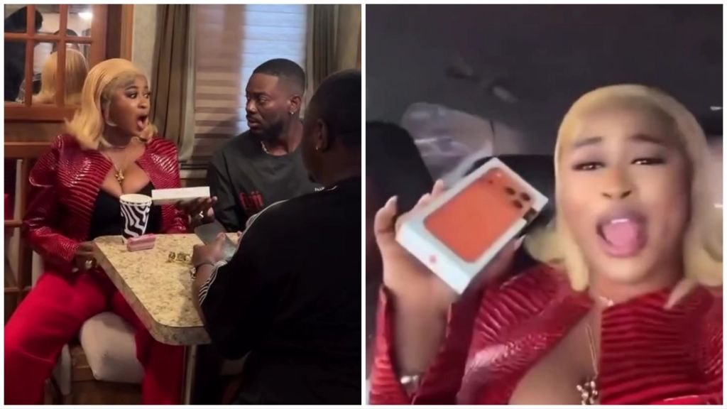 Side-by-side collage showing BBNaija Season 10 winner Imisi (Opeyemi Ayanwale) reacting joyfully as Adekunle Gold (Adekunle Kosoko) hands her a boxed iPhone 17 Pro Max in a lounge, and another frame of her excitedly displaying the orange-coloured phone box while seated in a car.