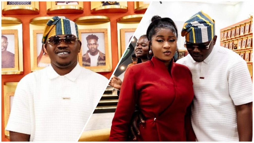 BBNaija stars Kuture and Imisi pose stylishly at a vibrant indoor event. Kuture rocks a white textured shirt paired with a multicoloured Yoruba cap and dark sunglasses, while Imisi looks elegant in a fitted red outfit, styled with subtle makeup and a sleek updo. The duo stand against a backdrop of framed portraits, radiating confidence and charm.