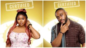 BBNaija Season 10 housemates Imisi and Kola pose in their official portraits against a gold background with the “Certified” logo above them.