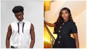 BBNaija stars Isabella and Koyin pose stylishly in separate portraits. Isabella stuns in a black short-sleeved dress with gold buttons while leaning on a staircase railing, exuding elegance. Koyin appears in a sleeveless white shirt paired with dark trousers, striking a confident pose against a plain background.