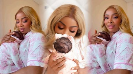 Toke Makinwa cradles and kisses her newborn daughter in matching pink pyjamas, showing a tender mother-daughter moment.