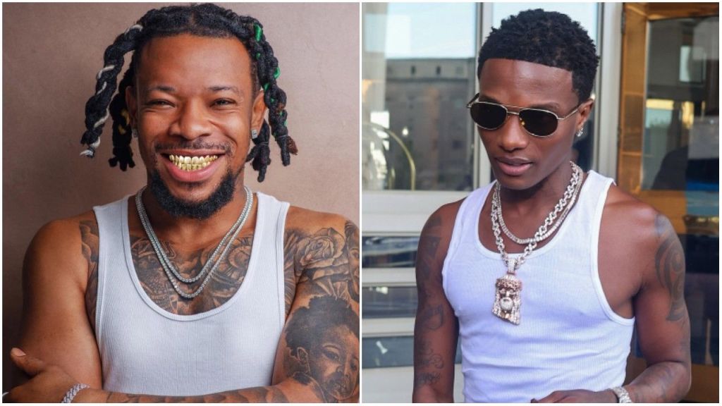 Nigerian singers Mr Real and Wizkid pictured in stylish white tank tops. Mr Real smiles broadly showing his gold grills, while Wizkid wears dark sunglasses and layered diamond chains with a pendant.
