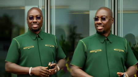 Obi Cubana smiles in twin-frame outdoor portraits wearing a green short-sleeved shirt with gold detailing.