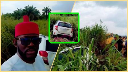 Nigerian singer J. Martins stands beside his white car, which veered off the Enugu–Aba–Port Harcourt Expressway into thick roadside grass after a reported brake failure. Nearby, bystanders and emergency responders assess the scene with another vehicle partly visible in the background.