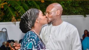 Natasha Osawaru and her husband, music star 2Baba, share a kiss during a public moment at an outdoor event.