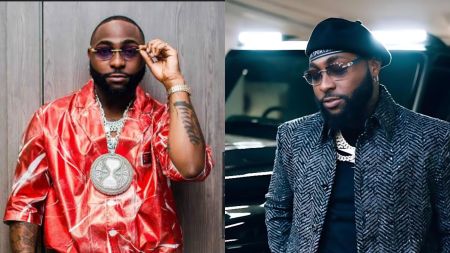 Davido wearing a shiny red outfit and large diamond pendant while adjusting his sunglasses.