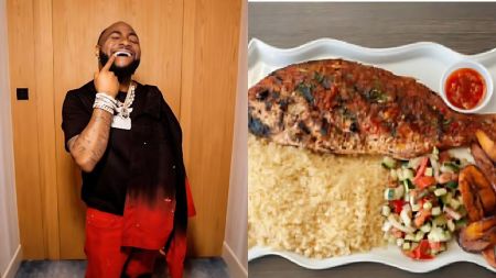 Davido smiles and points at his teeth while posing indoors beside a close-up photo of a grilled whole fish served with couscous, salad and fried plantain on a white platter.