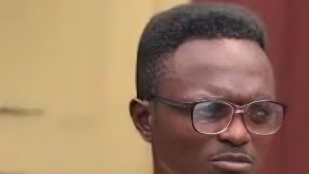 Nigerian music promoter K-Light wearing glasses looks serious during an interview.