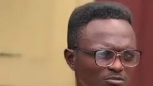Nigerian music promoter K-Light wearing glasses looks serious during an interview.