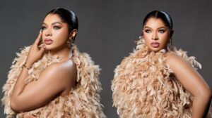 Side-by-side studio portraits of Liquorose wearing a feathered beige outfit, styled with sleek pulled-back hair, bold eye makeup and nude-pink lipstick, posing confidently against a dark grey background.