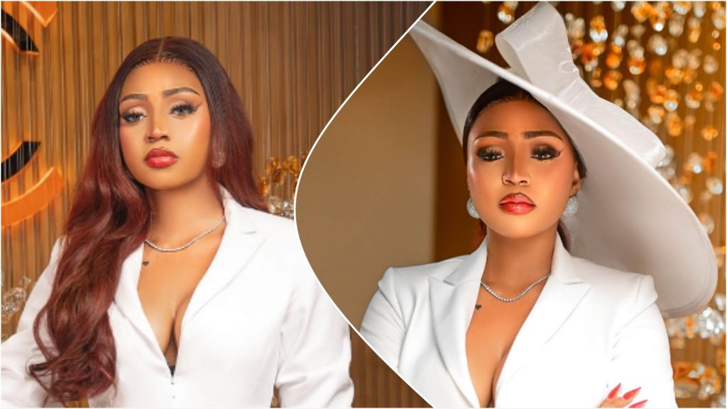 Side-by-side portrait of Regina Daniels wearing a white blazer in both photos, with one image showing her in long wavy hair and the other featuring her in a wide white hat, both shot indoors with warm decorative lighting in the background