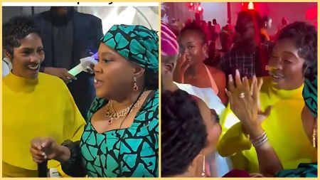 Side-by-side images from Toke Makinwa’s child dedication party showing Toyin Abraham in a green patterned aso-ebi outfit chatting warmly with Tiwa Savage, who is dressed in a bright yellow gown. In the first frame, both women smile while talking. In the second frame, they share a playful high-five gesture surrounded by other guests in a lively, red-lit party setting