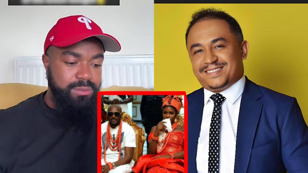 A bearded man wearing a red baseball cap sits on the left, looking down, while a smiling man in a blue suit and polka-dot tie appears on the right; between them is a small inset photo of 2Baba and his wife dressed in traditional red Edo attire during a ceremony.