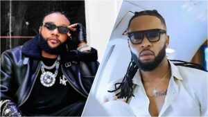 Side-by-side photo collage of Nigerian singers Kcee and Flavour, both wearing dark sunglasses. Kcee is dressed in a black leather jacket with layered chains, while Flavour appears in a white shirt inside a private jet.