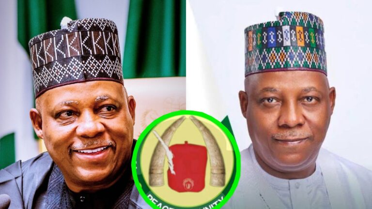 A side-by-side collage showing Nigeria’s Vice President Kashim Shettima. On the left, he is smiling while wearing a black traditional cap and dark outfit with the Nigerian flag blurred behind him. On the right, he appears in a lighter outfit with a multi-coloured traditional cap, facing the camera with a calm expression. At the centre bottom of the collage is a circular emblem featuring two elephant tusks and a red cap.