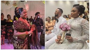 A wedding photo featuring Pastor Chris Okafor and his new wife, Pearl. The couple is seen in their wedding attire during the ceremony in Lekki, Lagos. Pastor Okafor is dressed in a formal suit, while his bride, Pearl, is in a white wedding gown, smiling alongside him in front of guests and family