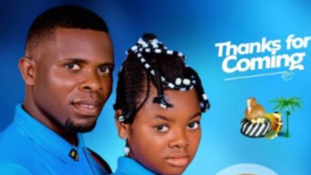 “Pre-wedding portrait of Michael and Angel, a Benue couple in matching blue outfits, standing side by side against a blue studio background.”