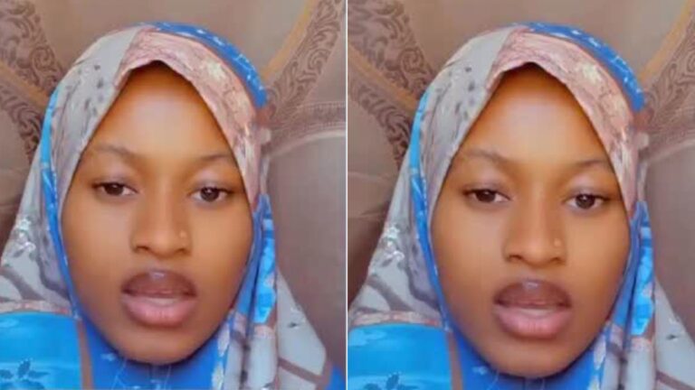 A Muslim woman wearing a patterned hijab speaks directly to the camera in a close-up selfie video.