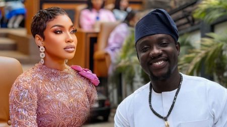 Tonto Dikeh sits elegantly in a beaded gown while VeryDarkMan smiles in a white traditional outfit beside her.