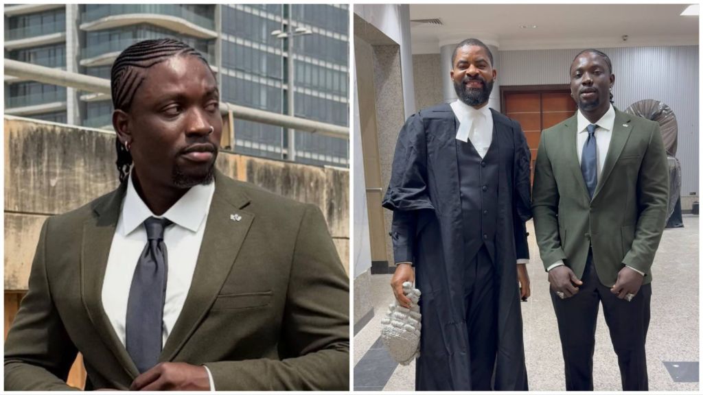 Verydarkman stands beside lawyer Deji Adeyanju in a courthouse hallway; Adeyanju is dressed in full legal robes and holding a white wig.
