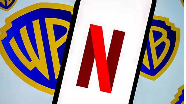 A smartphone screen showing the red Netflix “N” logo placed in front of multiple blue and gold Warner Bros shield logos.