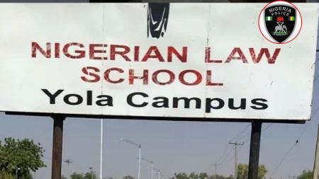 A large outdoor signboard displaying “Nigerian Law School Yola Campus” with a Nigeria Police logo placed in the top-right corner.