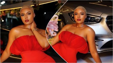 Nollywood actress Nancy Isime posing in a strapless red corset dress and signature blonde low-cut hairstyle, leaning against a silver Mercedes-Benz.