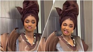 A split-screen image featuring Nigerian fashion influencer Priscilla Ojo posing in a structured, chocolate-brown pleated outfit with a matching elaborate head wrap (gele). She wears a statement necklace adorned with cowrie shells and black beads. On the left side, she offers a soft, composed smile, while on the right, she playfully winks and sticks her tongue out at the camera.