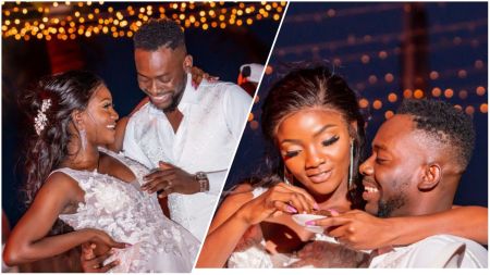 A split photo collage capturing romantic moments between Nigerian singers Simi and Adekunle Gold. On the left, the couple stands close together, smiling at one another, with Simi wearing a white lace dress and Adekunle Gold in a white shirt and vest. On the right, a close-up shows Simi affectionately feeding her husband a small treat while he beams with joy. The background features warm, blurred string lights indicative of an evening celebration.