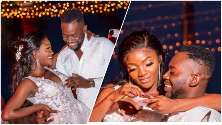 A split photo collage capturing romantic moments between Nigerian singers Simi and Adekunle Gold. On the left, the couple stands close together, smiling at one another, with Simi wearing a white lace dress and Adekunle Gold in a white shirt and vest. On the right, a close-up shows Simi affectionately feeding her husband a small treat while he beams with joy. The background features warm, blurred string lights indicative of an evening celebration.