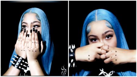 A split-screen composition showing two close-up portraits of North West. In both images, she has long, vibrant blue hair and is covering the lower half of her face with her hands. Her hands feature prominent dermal piercings across the knuckles and fingers, complemented by long black manicured nails. She wears a black leather cuff with silver spikes on her wrist.