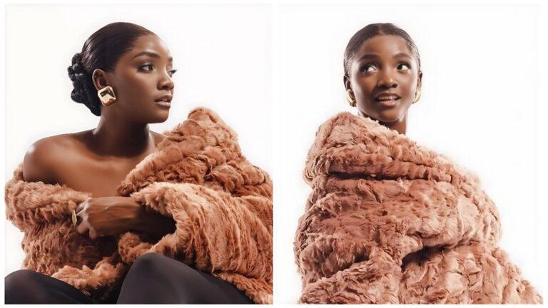 Two side-by-side portraits of Nigerian artist Simi against a bright white background. In both, she is wrapped in a voluminous, textured copper-brown faux fur coat. On the left, she is seen in profile with a sleek low bun and a bold, square gold earring, looking off-camera with a serene expression. On the right, she faces slightly forward with a playful, open-mouthed expression, her dark hair middle-parted and slicked back. The lighting is soft and high-key, emphasizing her radiant skin and the rich texture of the fur.